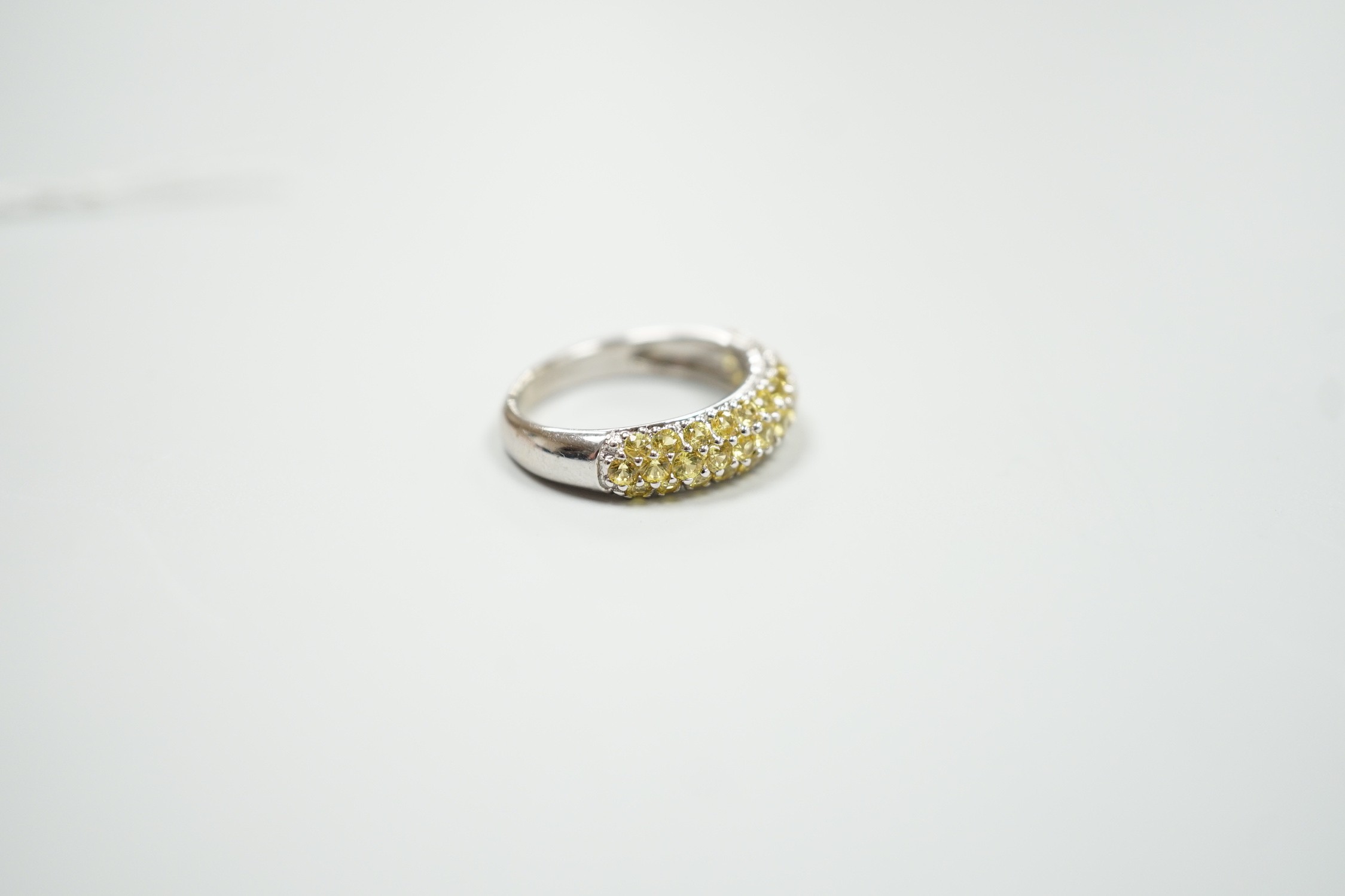 A modern 18ct white gold and yellow stone cluster set half hoop ring, size K, gross weight 4.2 grams.